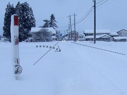 吹き溜まりで雪で埋まった自宅前道路